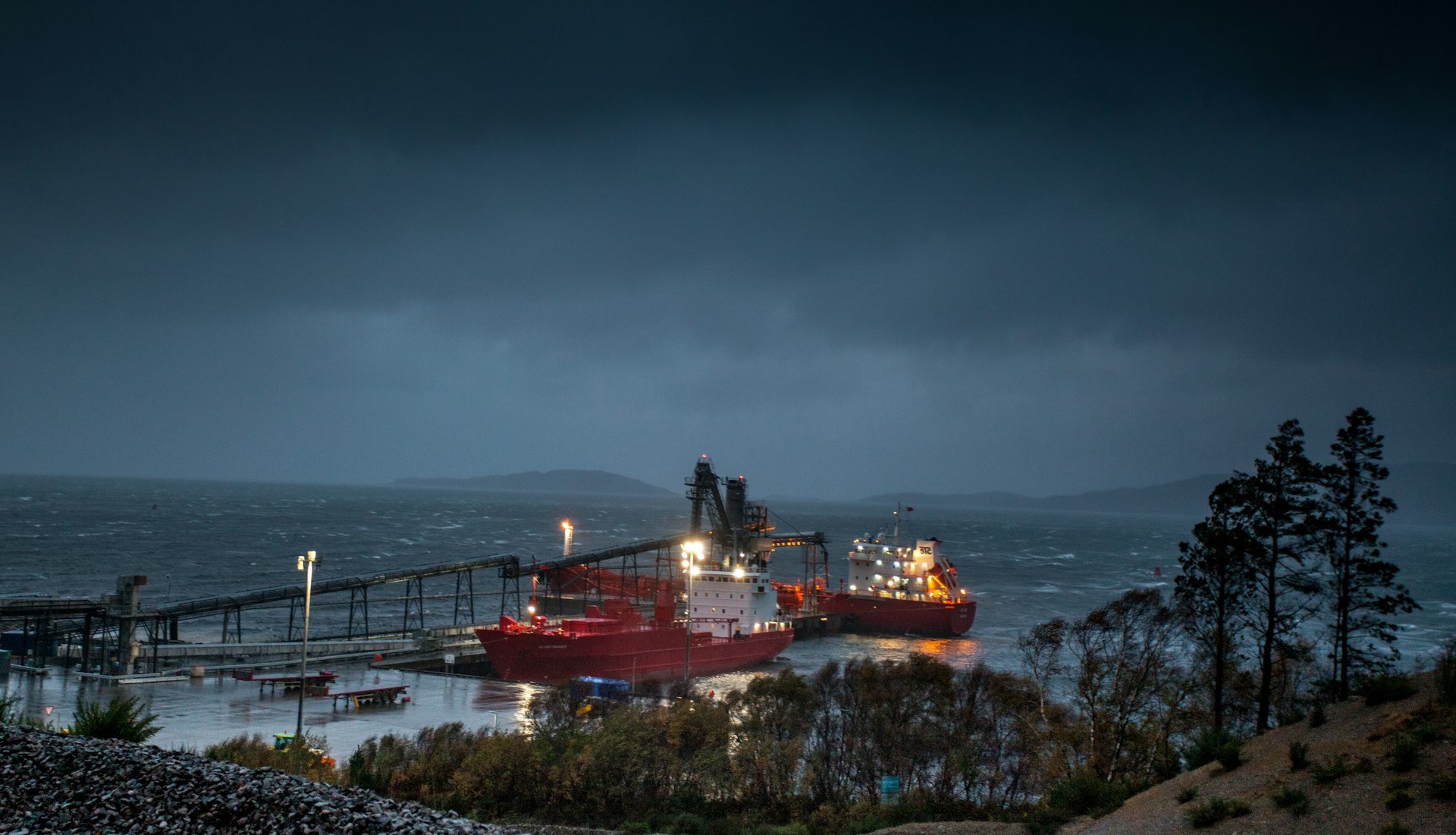 A large boat in a body of water under a cloudy sky